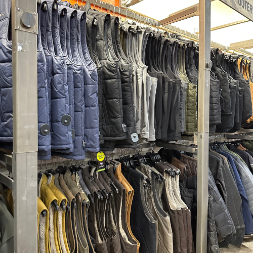 Jackets hung up on clothing racks inside of Rainbow Ag.