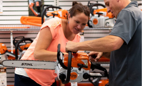 Rainbow Ag staff showing a customer a STIHL chainsaw